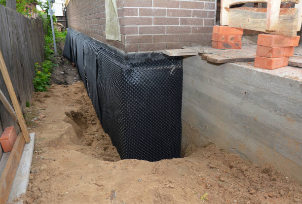 SJ Waterproofing Pros technician performing targeted Waterproofing assessment in Owensburg, IN
